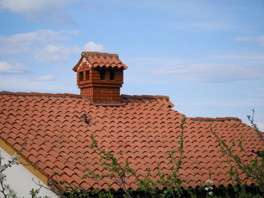 Finished clay-tiled roof with a chimney
